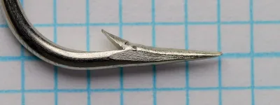 Mustad 3903 C Sproot Hooks — point detail showing hollow point geometry and barb — size 6/0 — close-up side angle