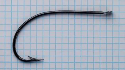Mustad Quak 9065 Kinsey Hooks — plan (overhead) view on measurement grid — size 9 — shows hollow point, barb angle, eye shape