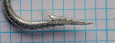 Mustad Gravitation size 15 — detail of point and barb geometry, showing superior point taper and barb angle — tinned finish