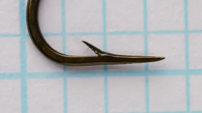 Mustad-Viking Hook No. 6 — profile view showing bent and point geometry — bronzed finish — on measurement grid