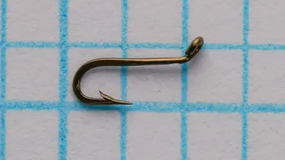 Mustad 94842 Viking size 14 — right profile showing hook gap, barb placement, and point geometry — hollow point on measurement grid