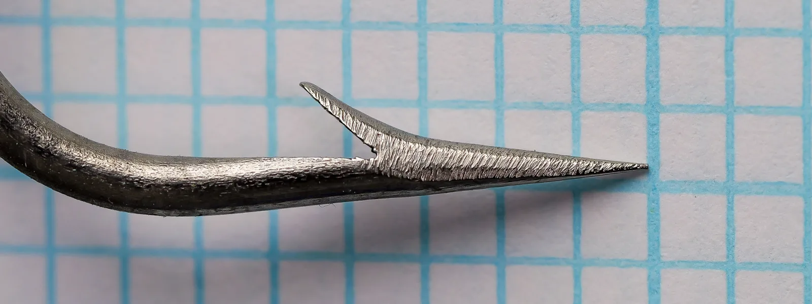R. Turner and Sons Cincinnati Bass Hooks No. 14 — side profile showing kirby offset and hollow point — fine-wire bright steel finish — on measurement grid