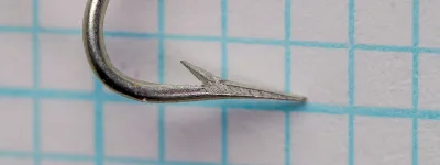 Mustad Quality 3193 Carlisle Hooks — side profile of hook bend showing kirbed offset and superior point — size 6, tinned finish — 0.1-inch measurement grid