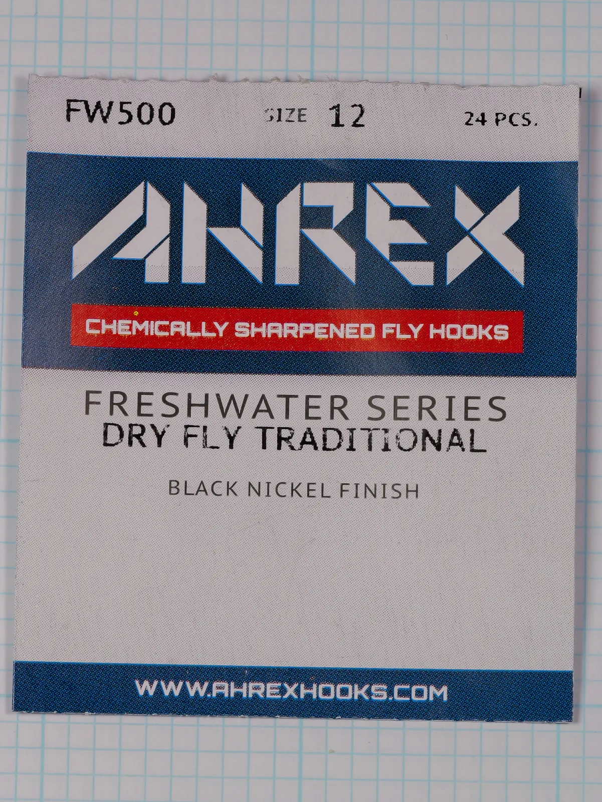 Front of a flat paper packet with a white AHREX logo on a dark blue band above a red band, and three lines of centered text.