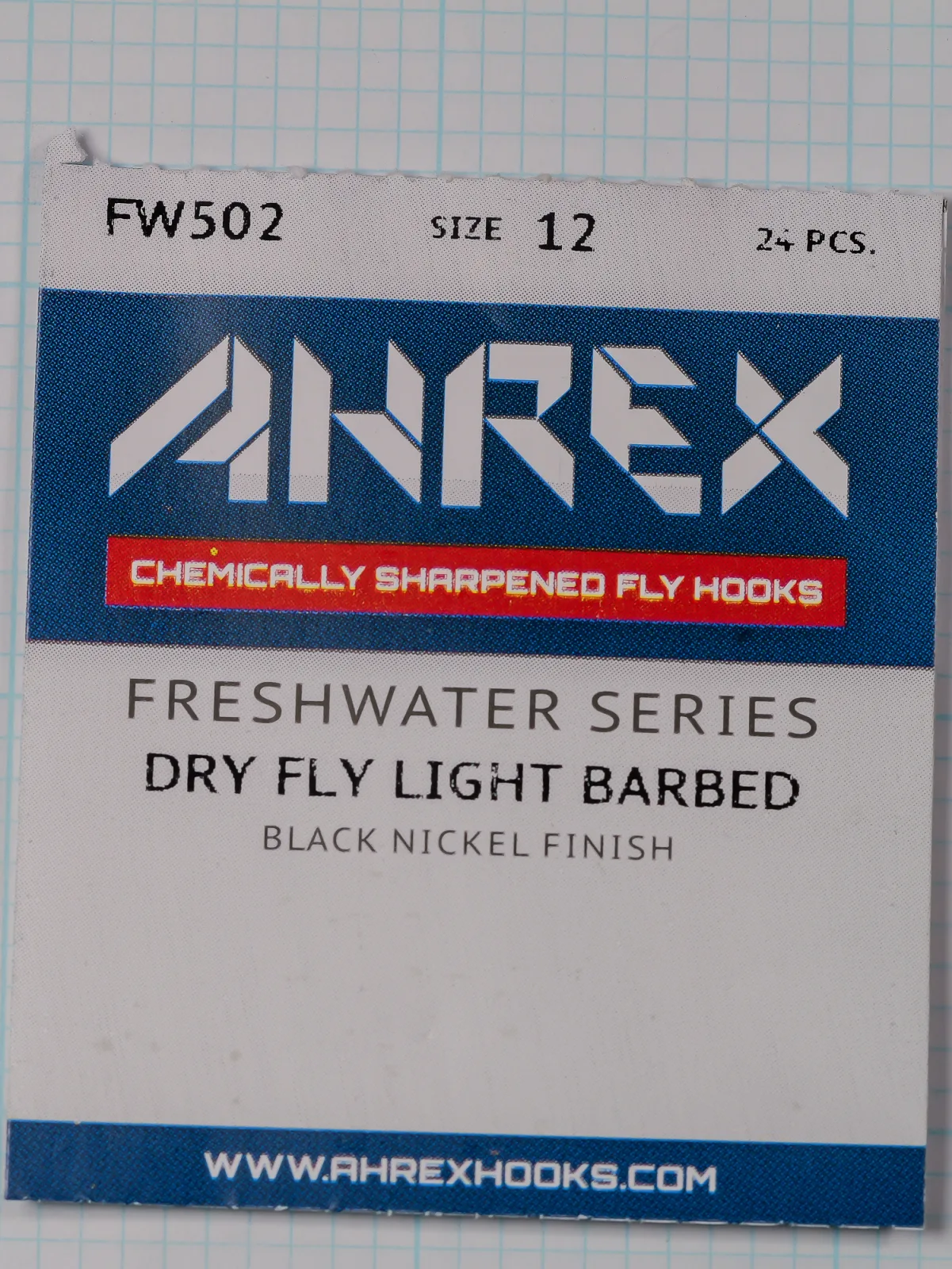 Front of an Ahrex FW502 size 12 packet with the blue AHREX banner, a red strip and the line Dry Fly Light Barbed.