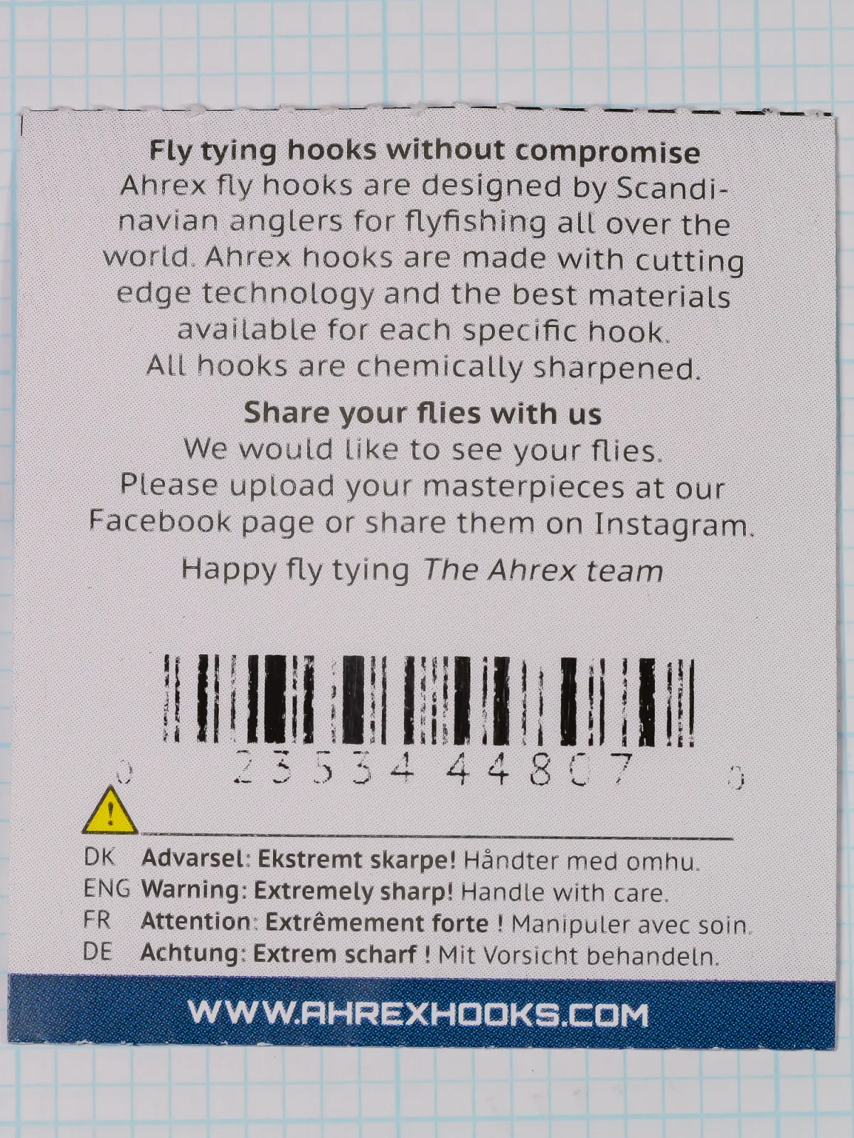 Back of the Ahrex FW503 packet showing maker text, a barcode with digits, a warning in four languages and the AHREX web address on a blue band.
