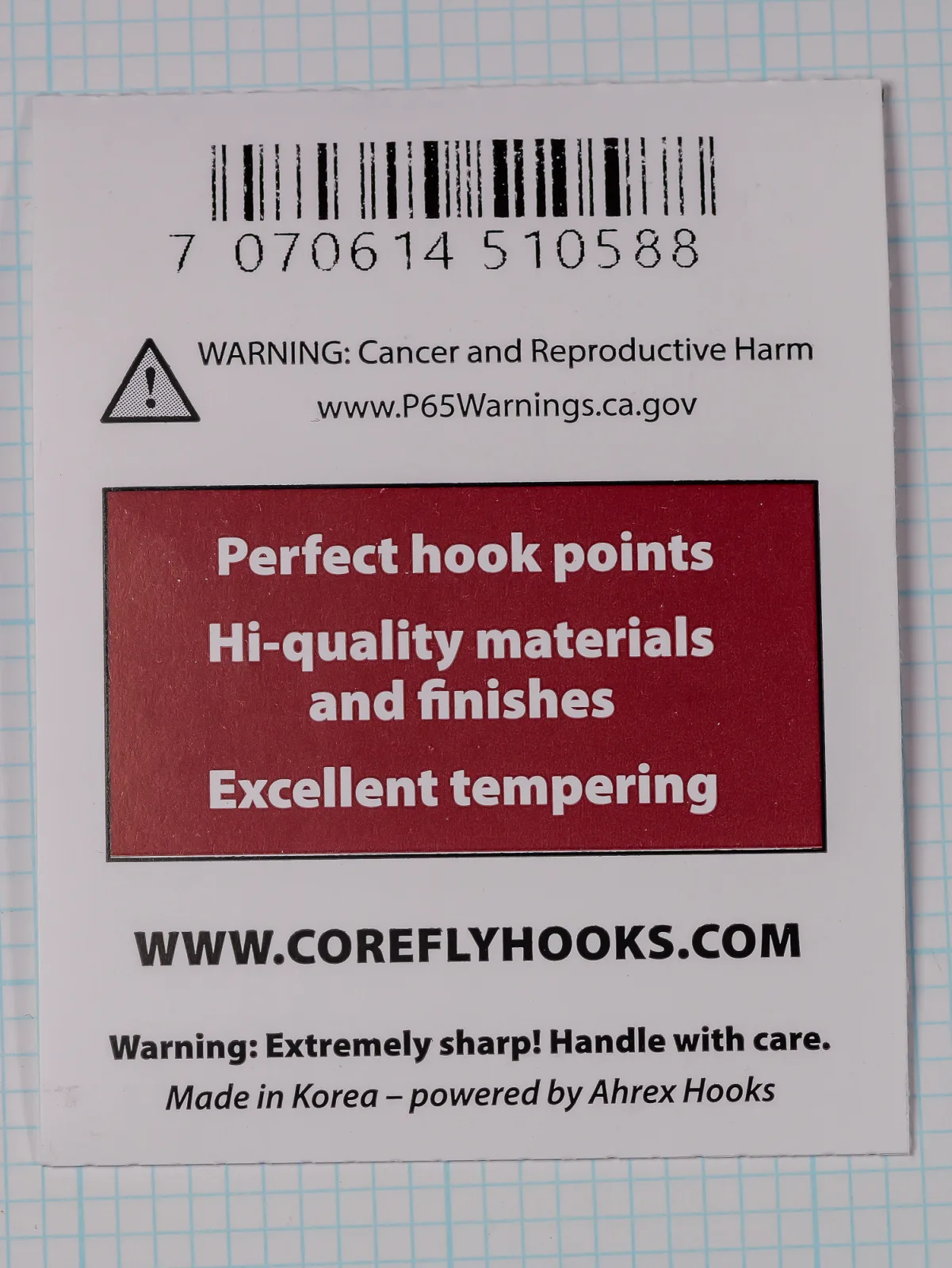 Back of a white card with a barcode, a warning notice and triangle icon, a maroon panel of white text, the Core web address and a made-in line.