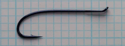 Blue-black Daiichi 2139 size 6 hook lying flat on grid paper, eye turned up at the right, point at lower left.