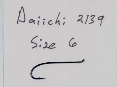 Handwritten card reading Daiichi 2139, Size 6, above a blue-black fish hook.