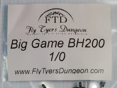 Paper label inside a clear plastic bag, printed with the FTD logo, Fly Tyers Dungeon, Big Game BH200, 1/0, and the web address, with hook eyes showing along the lower edge.