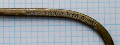 Close view of a struck legend, inverted in the photograph, reading IMP'D VAN VLECK HOOK.