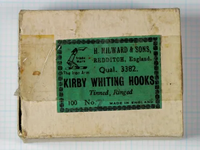 Cardboard box lid with a green printed label reading H. Milward & Sons, Qual. 3382, Kirby Whiting Hooks, Tinned, Ringed, with a handwritten size 2.