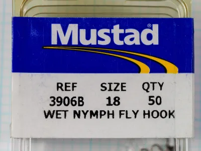Mustad 3906B size 18 plastic box with a blue, white and yellow Mustad sleeve.