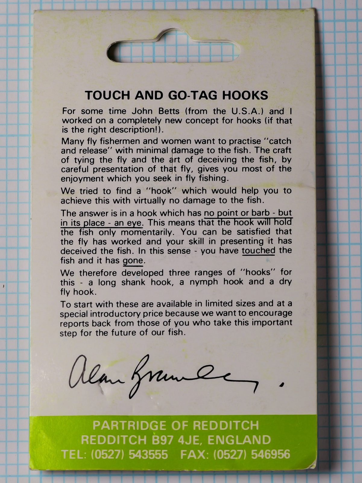 Back of the green Partridge Touch and Go Tag Hooks card, with printed text about the design, a printed signature and the Redditch address band.