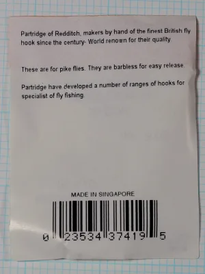 Back of a small white packet with three short paragraphs of printed text, the words MADE IN SINGAPORE and a barcode.