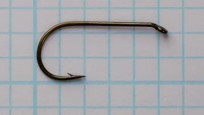 Partridge L4A hook in side view on a measurement grid: turned-down eye, round bend, plain shank and a barbed point.